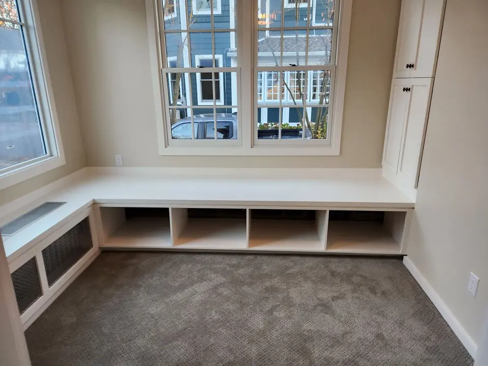Window seat with open cubbies under a double window